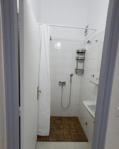 a bathroom with a shower with a shower curtain at your cute house in Salé