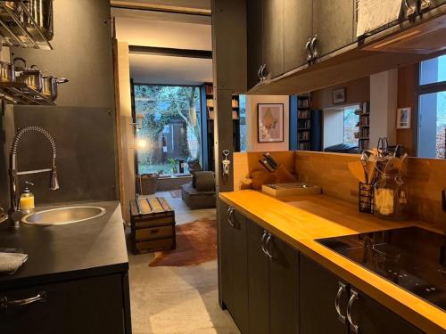 a kitchen with a sink and a counter top at Tailors Trail Beaufort Holiday Home and Rooms in Mullerthal in Beaufort