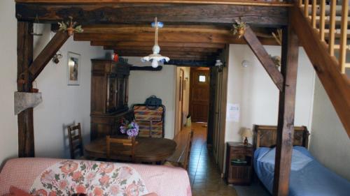 a bedroom with a bed and a wooden ceiling at La boulitte in Asnois