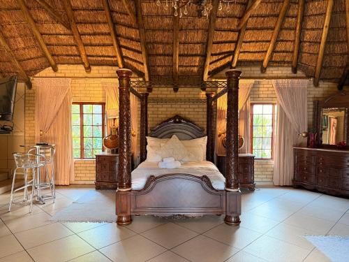 a bedroom with a bed and a wooden ceiling at Accommodation At Thabong in Brakpan