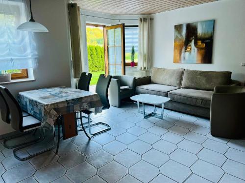 a living room with a couch and a table at Ferienwohnung Gründlinger in Weilersbach