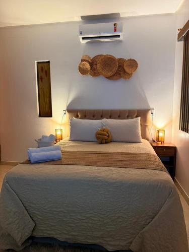 a bedroom with a large bed with a teddy bear on the wall at Villa Éden in Alter do Chao