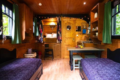 a bedroom with a bed and a table in a room at Le Moulin de Trévelo in Caden