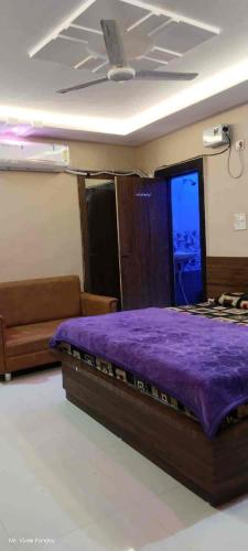 a bedroom with a purple bed in a room at Hotel shiv shakti yatri niwas in Maihar