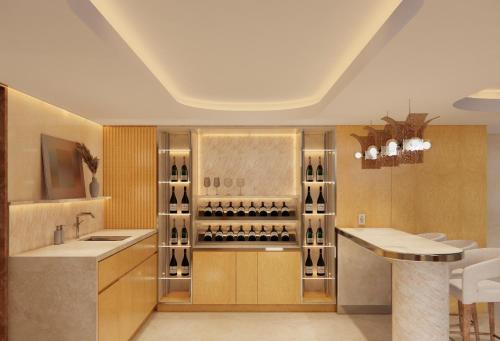 a kitchen with a counter and a wine cellar at Hotel Londres in Caracas