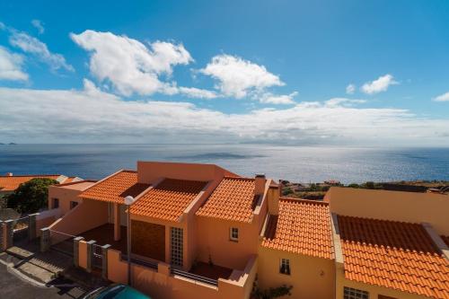 a view of a building with the ocean in the background at GuestReady - Alluring island retreat in Santa Cruz