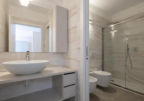 a bathroom with a sink and a shower and a toilet at Open Space - Garden & Jacuzzi in Milan