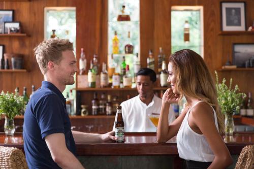 a man and a woman standing at a bar at Ka'ana Resort & Spa in San Ignacio