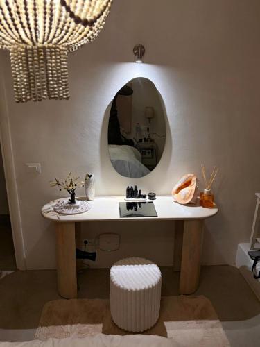 a bathroom with a table with a mirror on the wall at villa EYEONSUNSET - MAGICAL PLACE -PRIVATE pool -SEA and SUNSET VIEW -NO WIND - in Mikonos