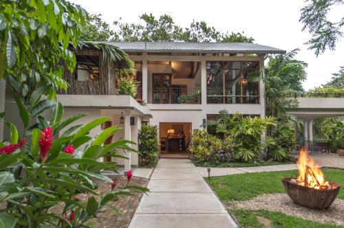 a house with a fire pit in the yard at Ka'ana Resort & Spa in San Ignacio