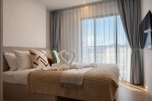 a bedroom with a bed with a large window at Work & Travel in Kathu