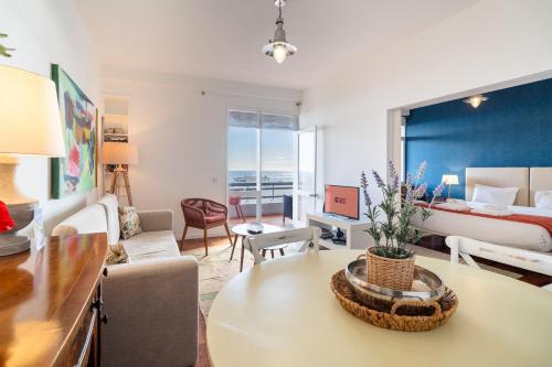 a living room with a couch and a bed and a table at Lido Mar - Hotels area in Funchal