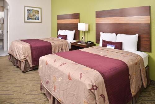 a hotel room with two beds in a room at Americas Best Value Inn Downtown Houston in Houston