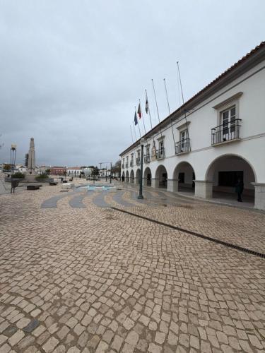 a building with flags on the side of it at Arcada House Tavira in Tavira