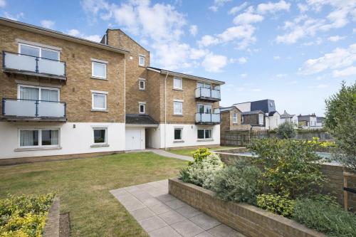 an image of an apartment building with a yard at Roomspace Serviced Apartments - Cascades Court in London