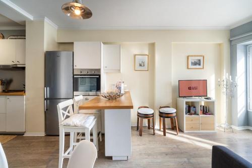 a kitchen with a refrigerator and a table and chairs at Barreirinha II Near Old Town With Nice Ocean Views in Funchal