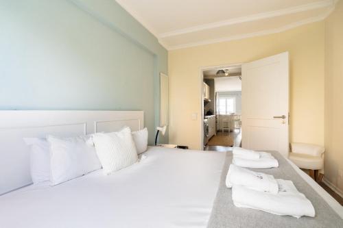 a bedroom with a white bed with white pillows at Barreirinha II Near Old Town With Nice Ocean Views in Funchal