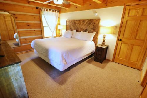 a bedroom with a white bed in a room with a window at The Meadows in Cherokee