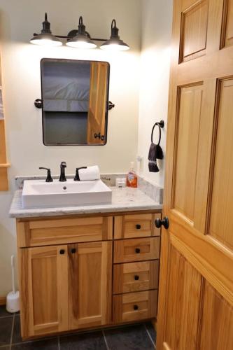 a bathroom with a sink and a mirror at The Meadows in Cherokee