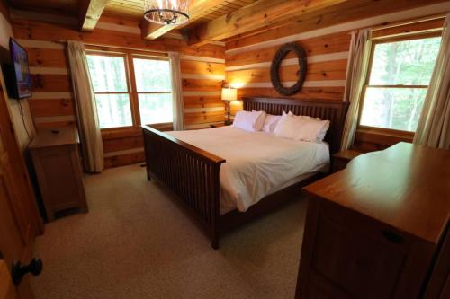 a bedroom with a bed in a log cabin at The Hilltop in Cherokee