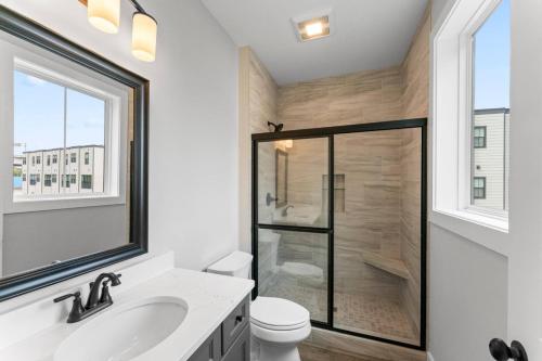 a bathroom with a shower with a toilet and a sink at McCormick Retreat in Knoxville