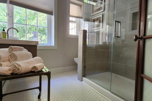 a bathroom with a shower and a glass shower stall at The Nama Retreat 201 - Renovated Downtown Loft near Gay St | Walk Everywhere in Knoxville