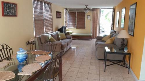 a living room with couches and tables at Ocean View in La Parguera