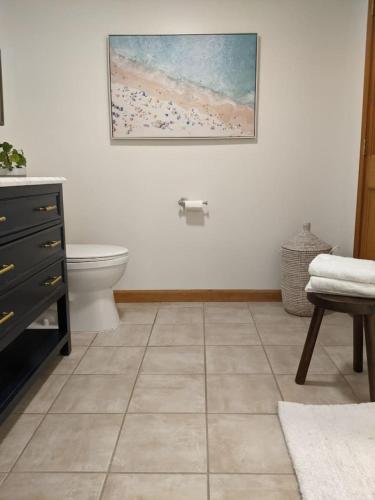 a bathroom with a toilet and a painting on the wall at Lawrenceville Escape in Lawrenceville