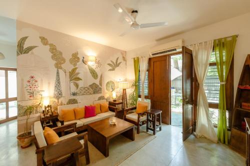 a living room with a couch and a table at Art KOTHI Gurgaon in Gurgaon