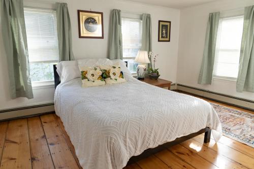 a bedroom with a bed with two teddy bears on it at The Garden House in Saco