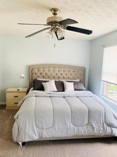 a bedroom with a bed with a ceiling fan at Covington Station Escape in Lithonia