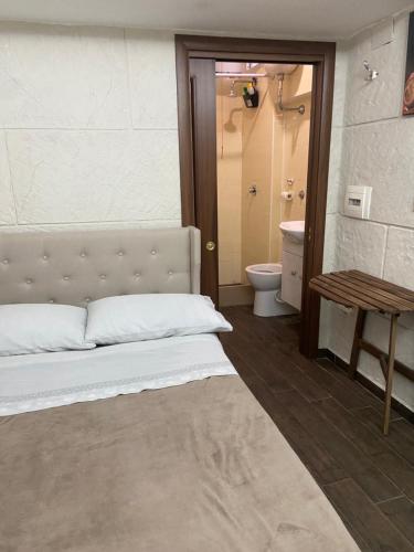 a bedroom with a bed and a bathroom with a toilet at b&b ERCOLANO Scavi in Ercolano