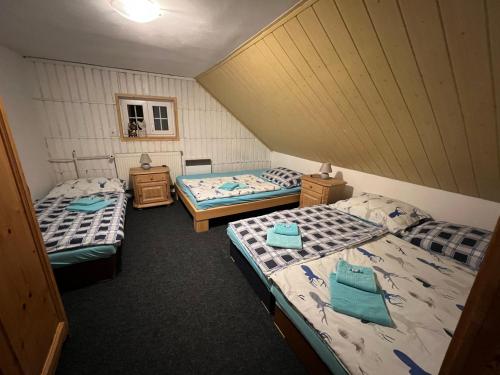 an overhead view of a room with three beds at Apartmány U Kocoura pod Klínovcem in Kovářská