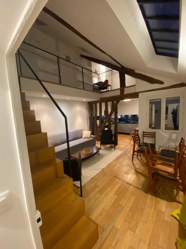 a living room with stairs leading to a bedroom at Duplex château de Versailles - 30 min de Paris in Versailles