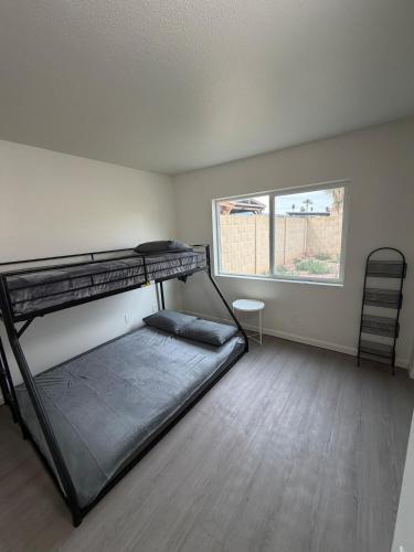 a room with two bunk beds and a window at Spring Training Special Comfy 3 Bedroom in Phoenix