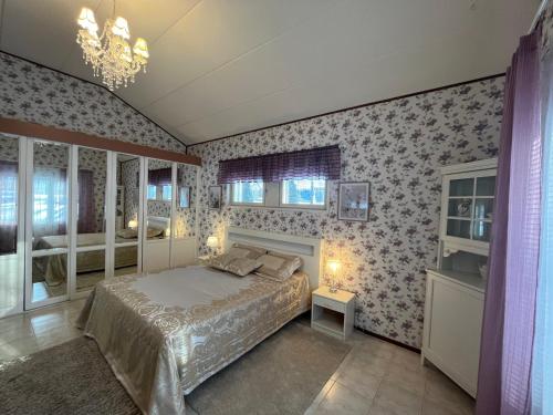 a bedroom with a bed and floral wallpaper at Lake Suite Family in Lahti
