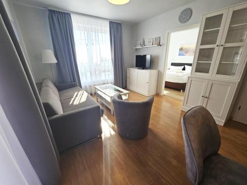 a living room with a couch and a room with a bed at Appartementhaus Binzer Sterne 11 in Binz