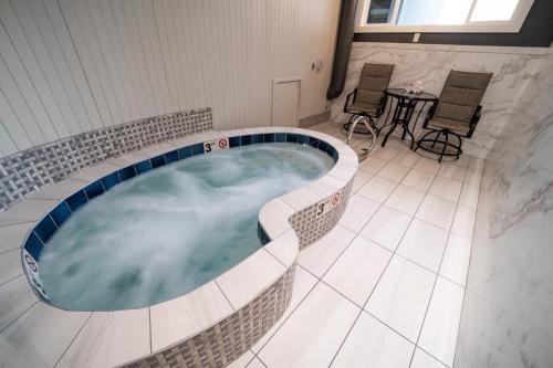 a hot tub in a room with a table and chairs at Clover Creek Inn in Montpelier