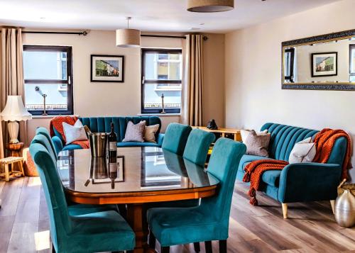 a dining room with a table and blue chairs at The Suite at O'Shea's in Killorglin