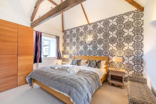 a bedroom with a bed and a table and a chair at 3 Bed in nr Beadnell oc-cr1279 in Beadnell