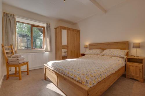 a bedroom with a bed and a window and a chair at 2 Bed in Settle oc-ds1038 in Settle