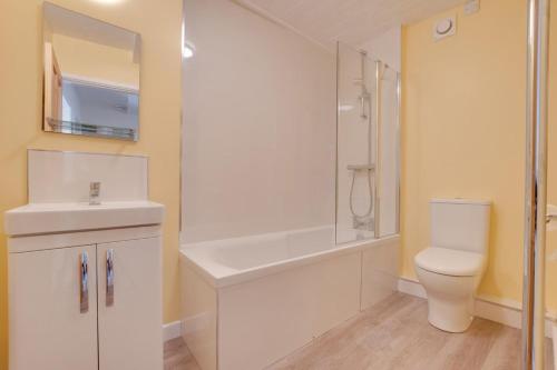 a bathroom with a toilet and a sink and a shower at 2 Bed in Settle oc-ds1038 in Settle