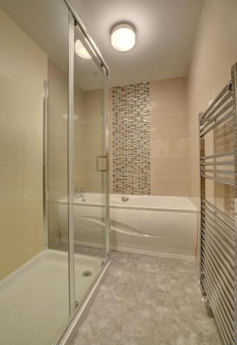 a bathroom with a shower and a bath tub at 2 Bed in Woolacombe oc-narr9 in Woolacombe