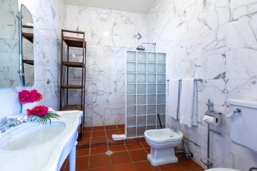 a white bathroom with a sink and a toilet at Villa Landhuis 6 - Coral Estate in Willibrordus