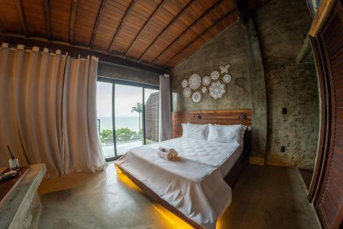 a bedroom with a bed with a teddy bear on it at Contemporary architecture by the sea in Búzios