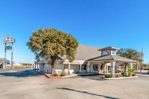 a gas station with a tree in front of it at Knights Inn San Antonio near Frost Bank Center in San Antonio