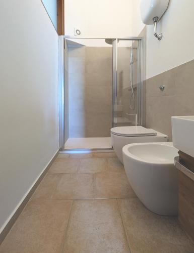 a bathroom with a shower and a toilet and a sink at TheSuperhost - Aquaria - Vista Mare in Crotone
