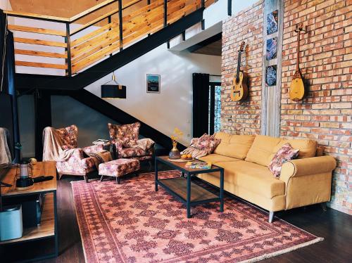 a living room with a couch and a table at Alexa Mountain Homes in Kok-Shoky