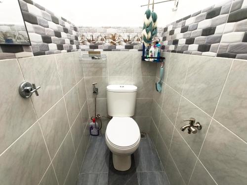 a bathroom with a white toilet in a room at White House Villa in Sekinchan