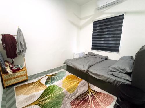 a small bedroom with a bed and a window at White House Villa in Sekinchan